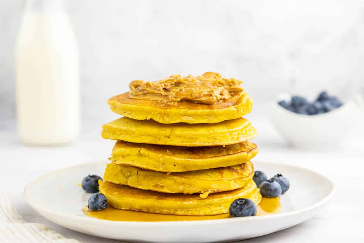 Healthy protein pancakes stacked with peanut butter