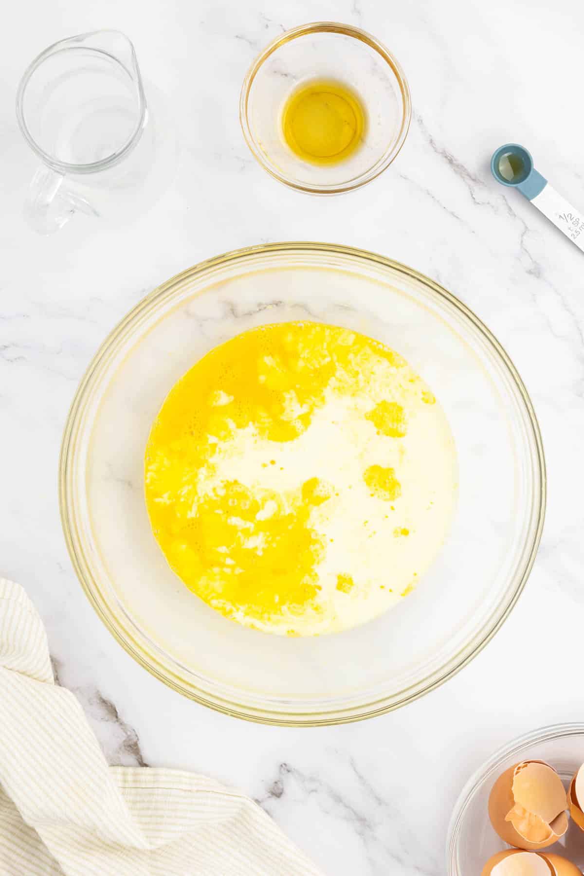 Eggs, maple syrup, vanilla extract, and milk in a large bowl