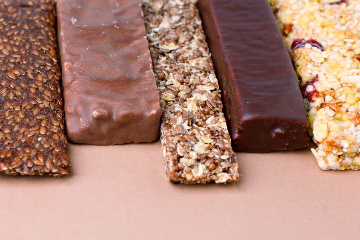 A range of different weight gain bars unpackaged on a counter top