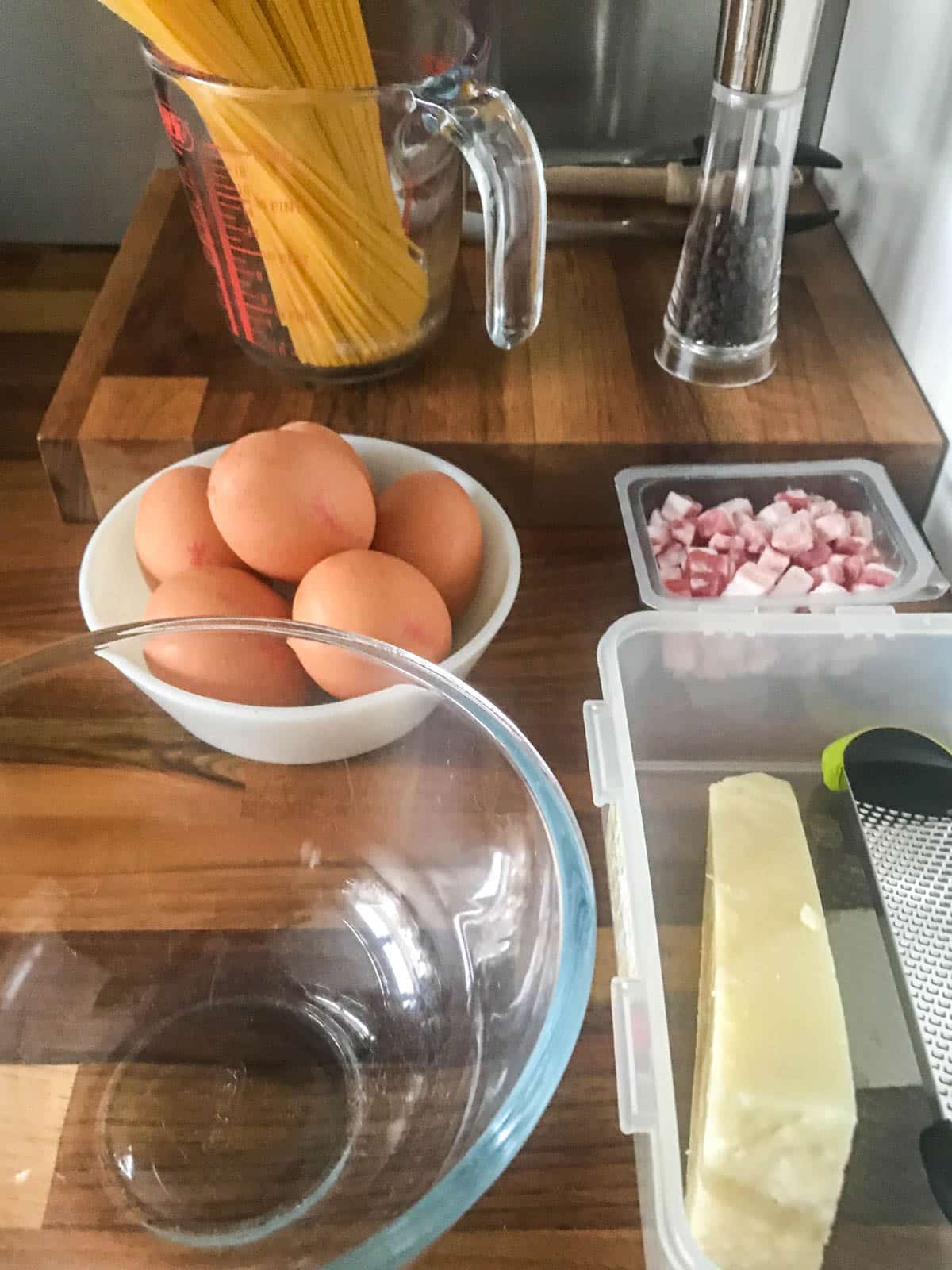 Ingredients portioned in containers - Spaghetti, eggs, pancetta and pecorino romano