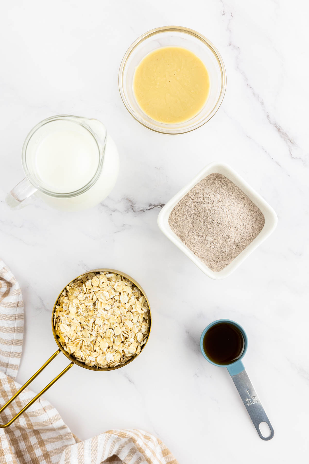 Ingredients for the high calorie oatmeal portioned  and on a kitchen counter