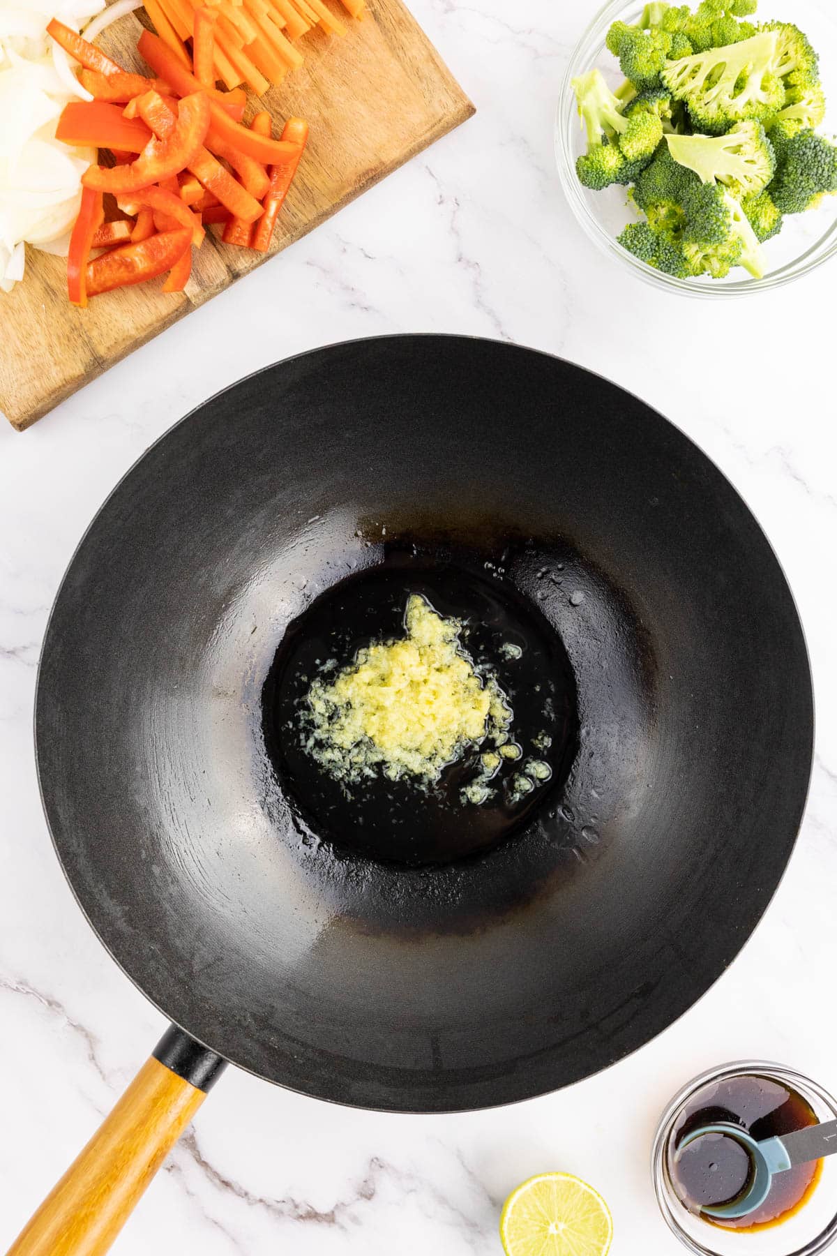 Sautéing garlic and ginger in a wok with oil
