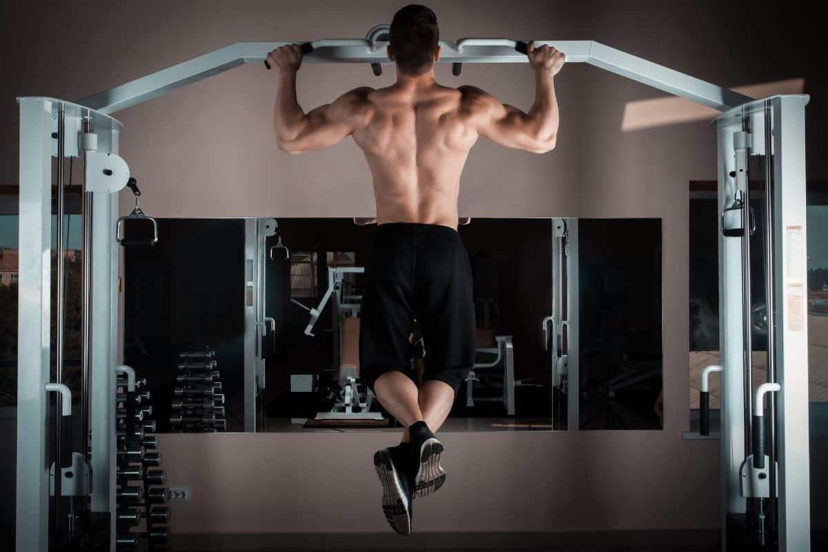 10 Best Exercises for Weight Gain 9 Person doing a pull up on a pull up bar.