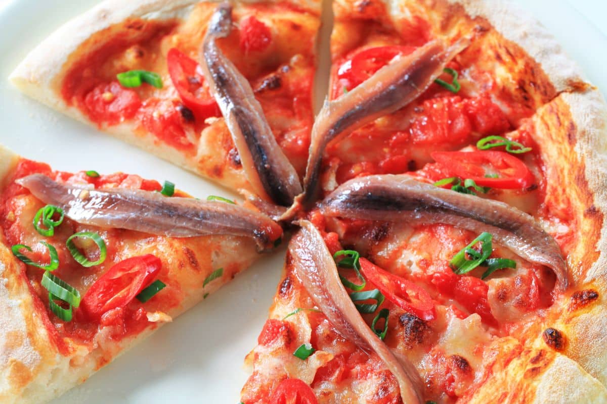 20 Highest Protein Fish and Seafood 3 Anchovy pizza cut into slices.