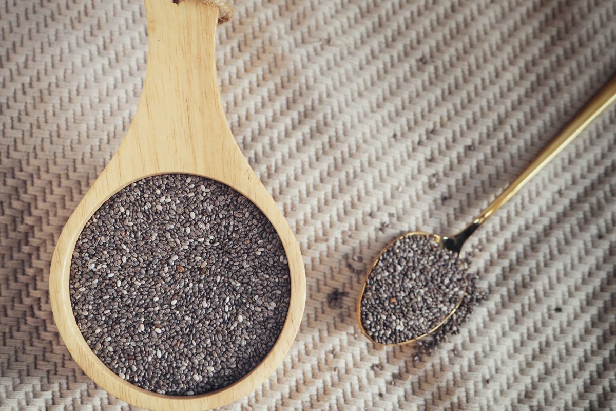 Chai seeds in a cup and a tablespoon.