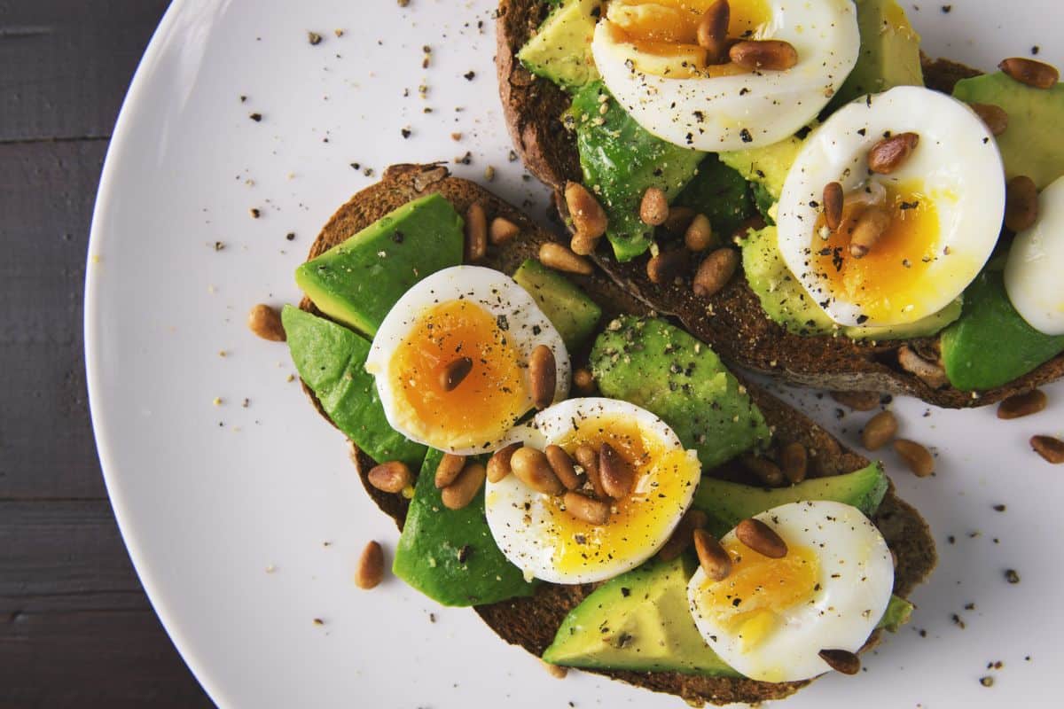 Eggs on toast with avocado and seeds.