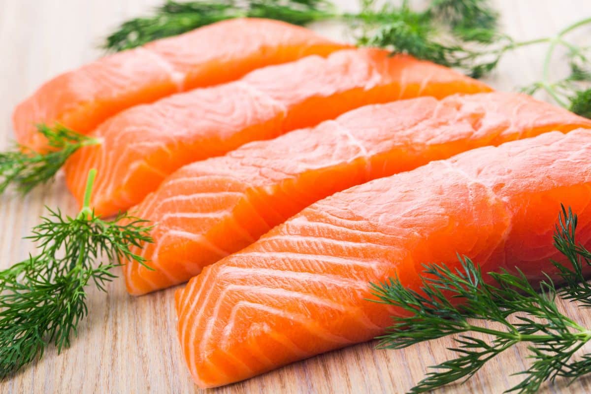 Salmon fillets on a wooden board.