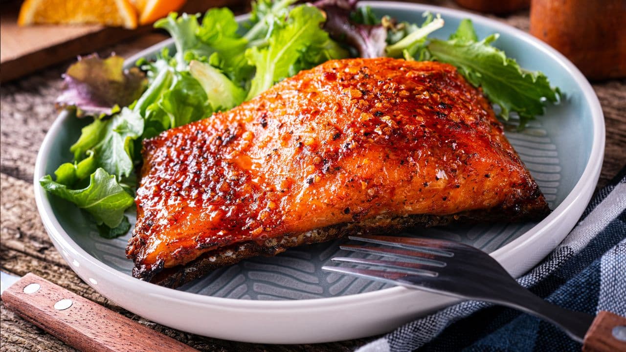12 Healthy Foods That Can Speed Up Muscle Gain 8 Baked salmon on a table.