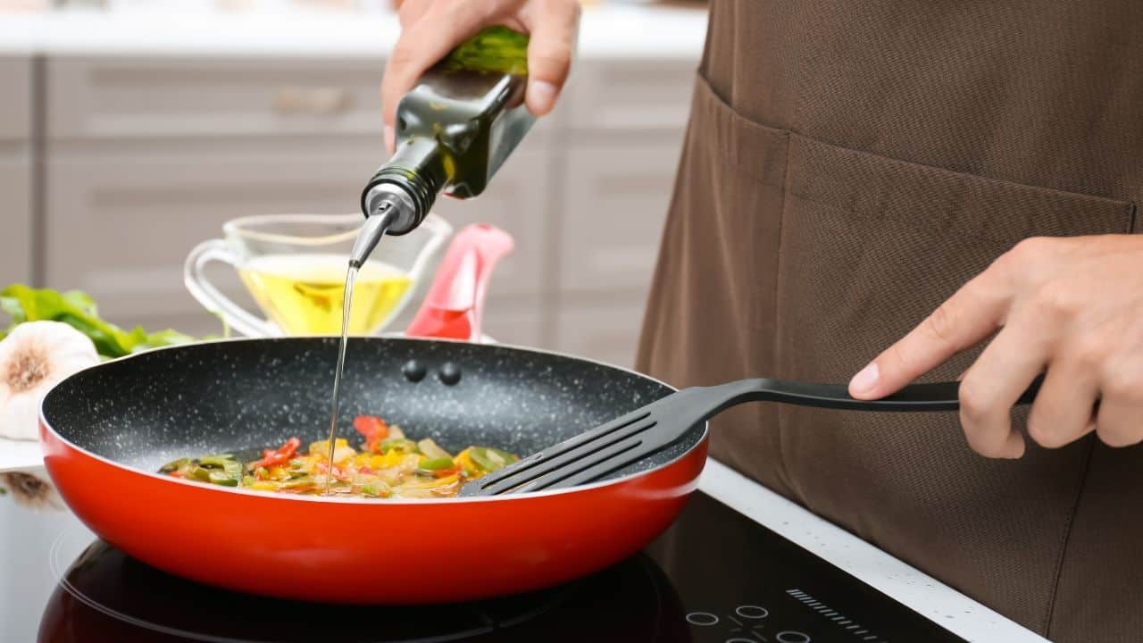 9 Everyday Foods That Quietly Add Hundreds of Calories 3 Pouring oil into a pan