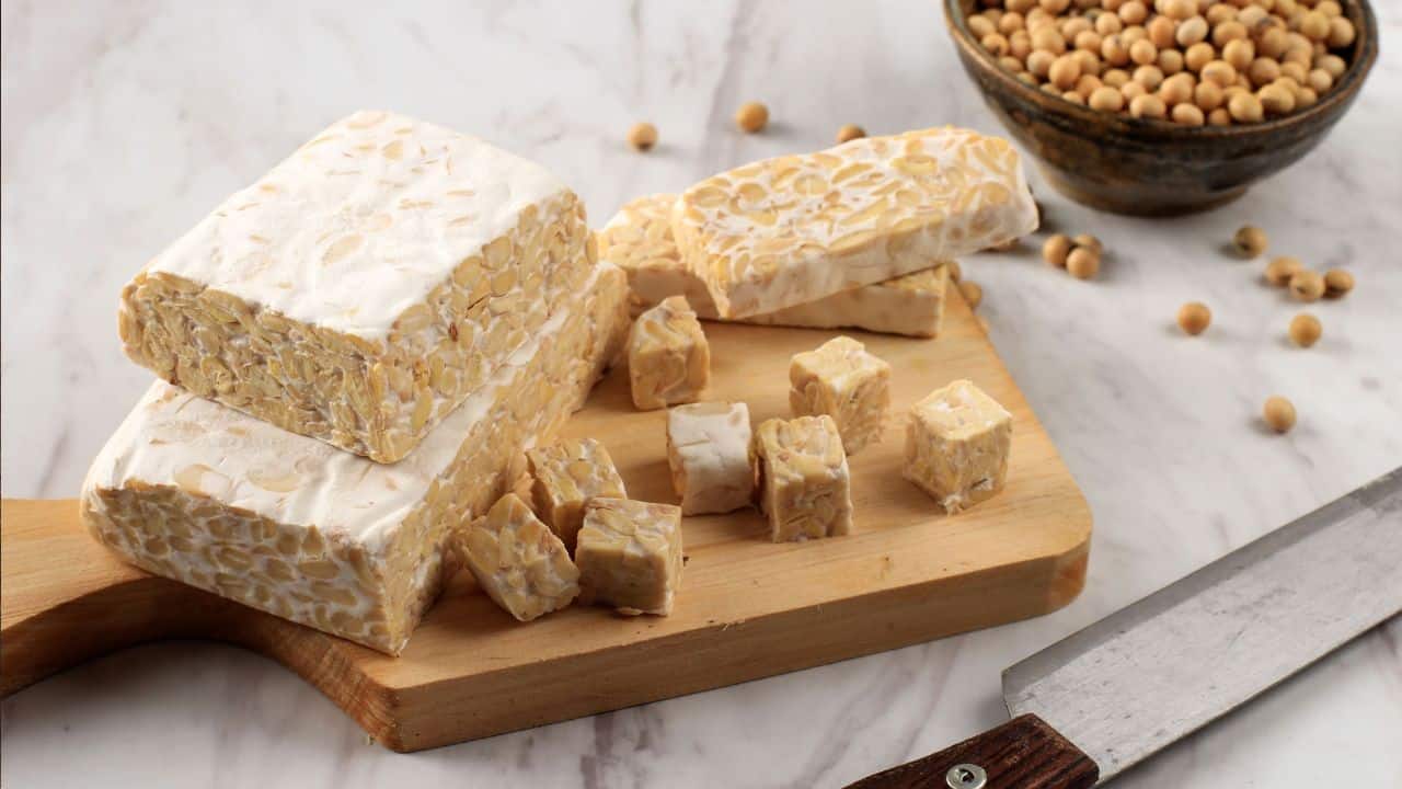 7 Surprising High-Protein Foods That Aren’t Meat 5 Tempeh on a wooden board